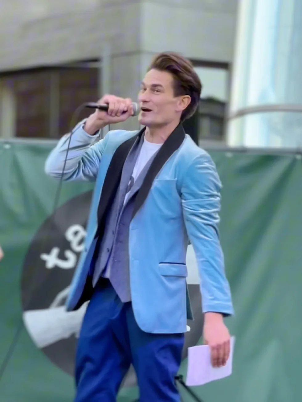 John hosting live on stage with a microphone